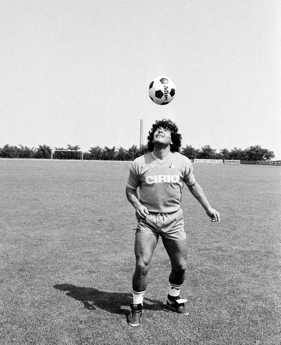 Diego Maradona playing with ball retro black white
